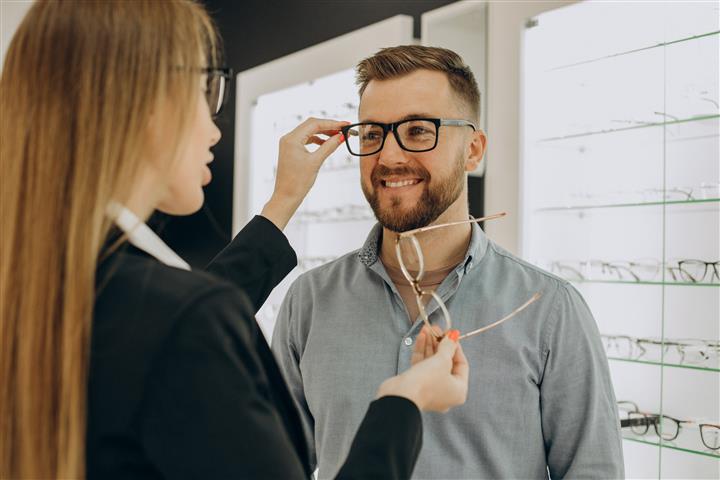 Man trying on glasses
